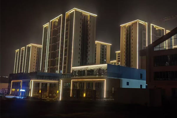 A beautifully lit modern building facade at night with no visible glare or light pollution